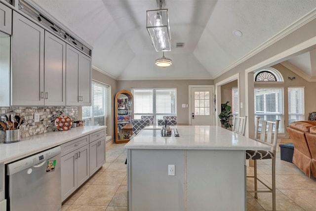 2134 Kilkenny Dr, Pearland, TX 77581 - kitchen featuring dishwasher, vaulted ceiling, backsplash, a kitchen bar, and open floor plan