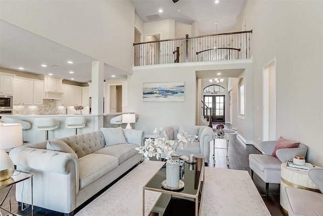 23907 Birchwood Lake Ln, Katy, TX 77493 - living area with dark wood-style floors, recessed lighting, a high ceiling, a chandelier, and stairway