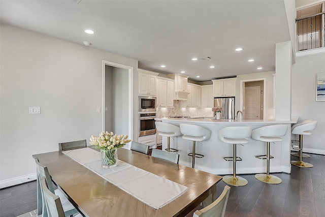 23907 Birchwood Lake Ln, Katy, TX 77493 - dining space featuring baseboards, dark wood-style floors, and recessed lighting