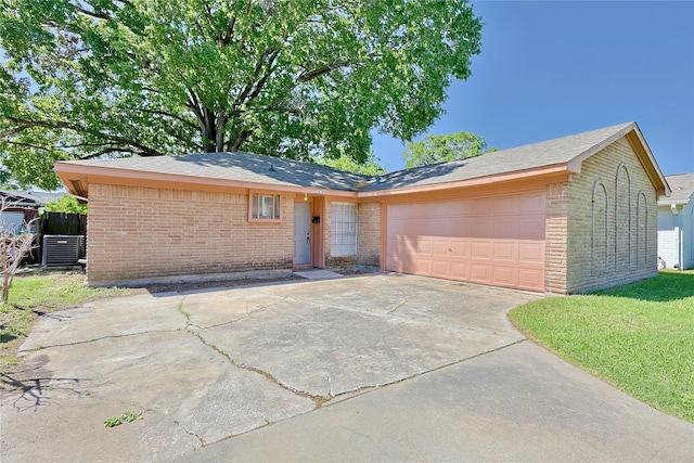 single story home with concrete driveway, a shingled roof, brick siding, and a garage