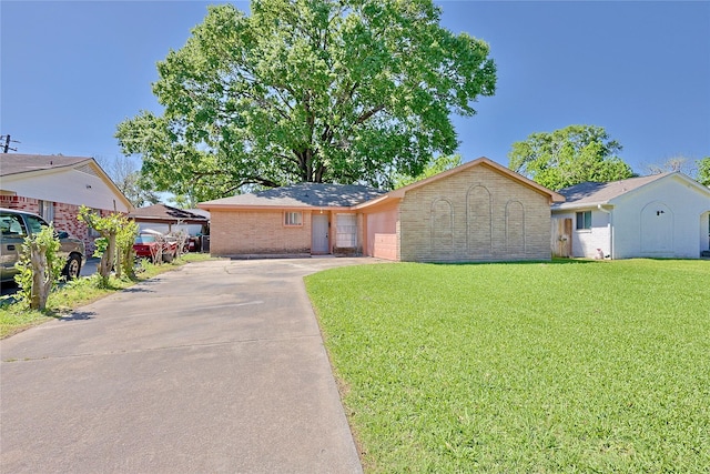 single story home with a front lawn, brick siding, driveway, and a garage