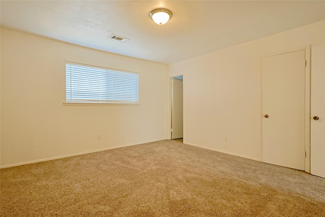 carpeted empty room with visible vents