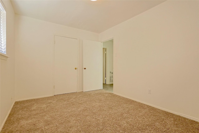 empty room with baseboards and carpet floors