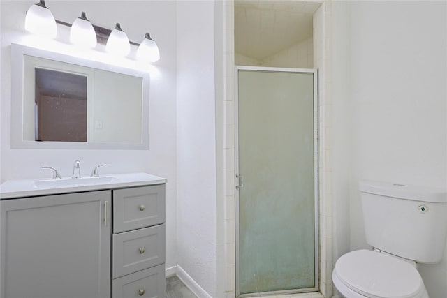 full bathroom with a stall shower, vanity, toilet, and baseboards