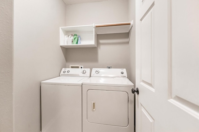washroom featuring laundry area and separate washer and dryer