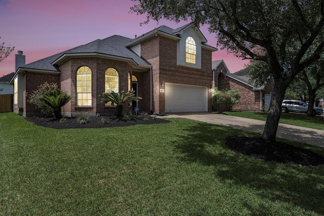 view of front of home featuring a chimney, driveway, brick siding, a garage, and a front lawn