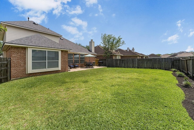 view of yard featuring a patio and a fenced backyard