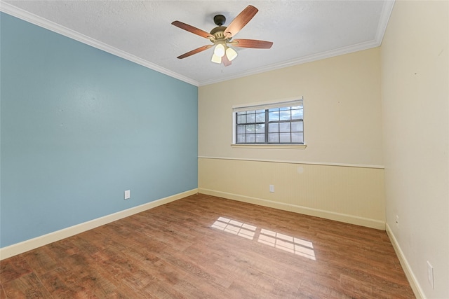 unfurnished room with baseboards, ceiling fan, crown molding, and wood finished floors