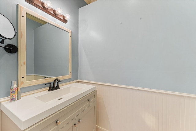 bathroom featuring vanity and a wainscoted wall