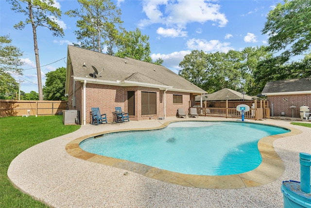 view of pool featuring a fenced backyard, a patio area, a fenced in pool, and a lawn