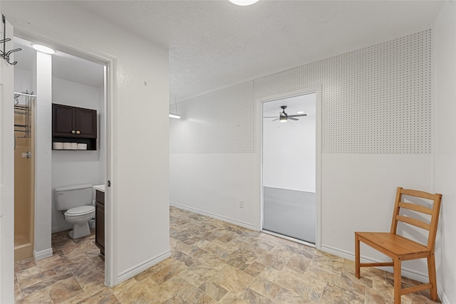 interior space with baseboards and stone finish floor