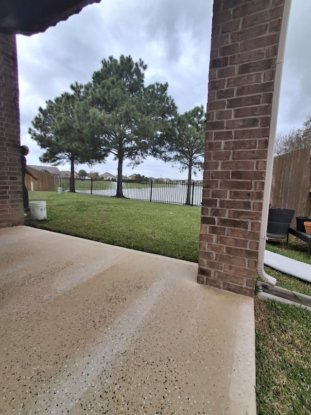 25215 Quiet Run Trl, Richmond, TX 77406 - exterior space featuring fence, a water view, and a patio area