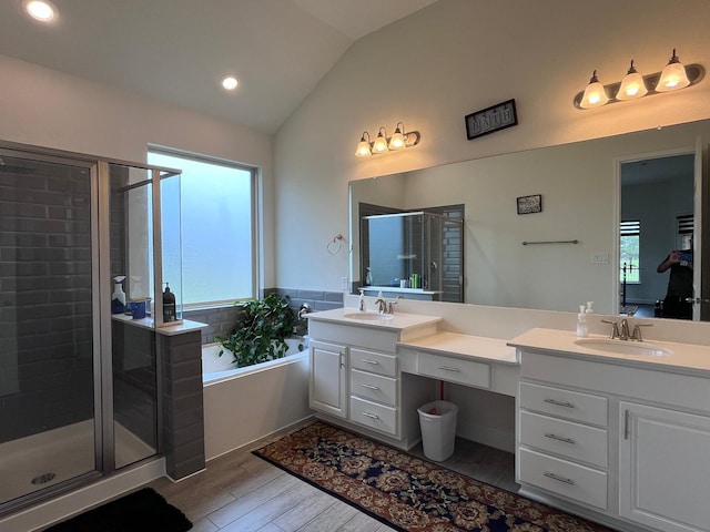 25215 Quiet Run Trl, Richmond, TX 77406 - bathroom featuring wood finished floors, a bath, lofted ceiling, a shower stall, and vanity