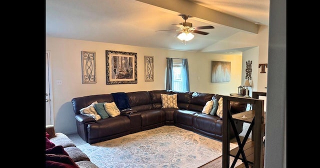 carpeted living room featuring ceiling fan and lofted ceiling with beams