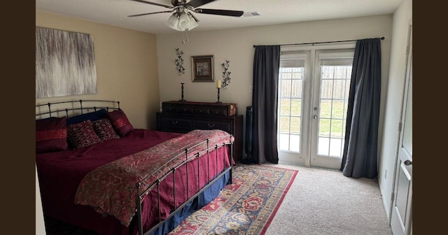 carpeted bedroom with multiple windows, ceiling fan, visible vents, and access to exterior