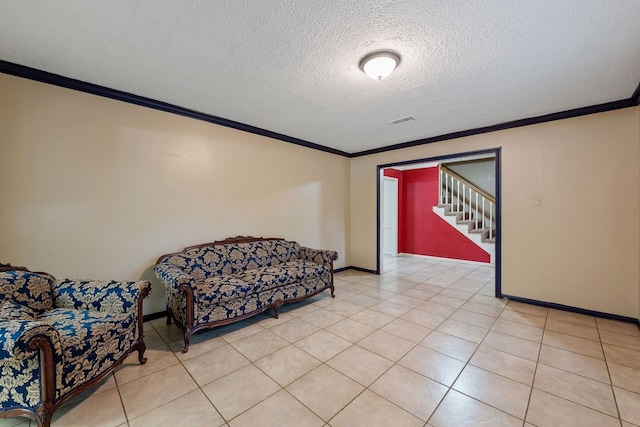 sitting room featuring crown molding, a textured ceiling, stairway, baseboards, and visible vents