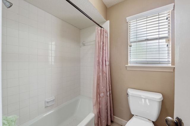 full bathroom with toilet, baseboards, and shower / tub combo
