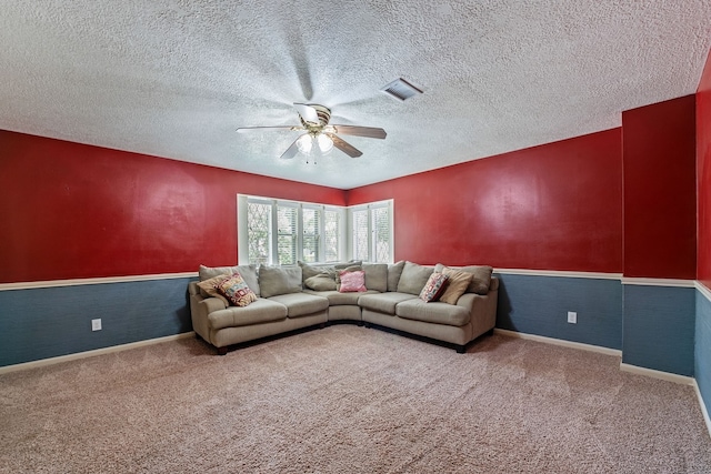 carpeted living room with a ceiling fan, baseboards, visible vents, and a textured ceiling