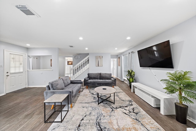 living room featuring wood finished floors, visible vents, recessed lighting, stairway, and baseboards