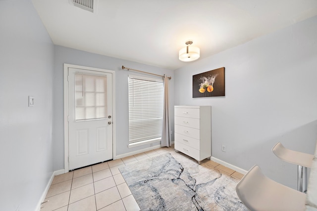 interior space with light tile patterned floors, baseboards, and visible vents