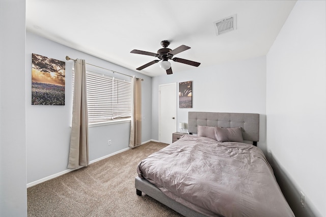 carpeted bedroom with ceiling fan, baseboards, and visible vents