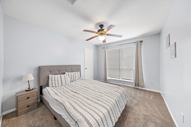 carpeted bedroom with baseboards, a ceiling fan, and visible vents