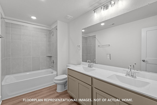 5042 Celestial Ct, La Marque, TX 77563 - bathroom featuring wood finished floors, toilet, double vanity, washtub / shower combination, and recessed lighting