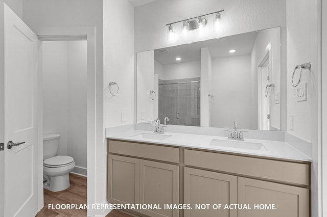 5042 Celestial Ct, La Marque, TX 77563 - full bathroom with a shower stall, toilet, wood finished floors, and double vanity