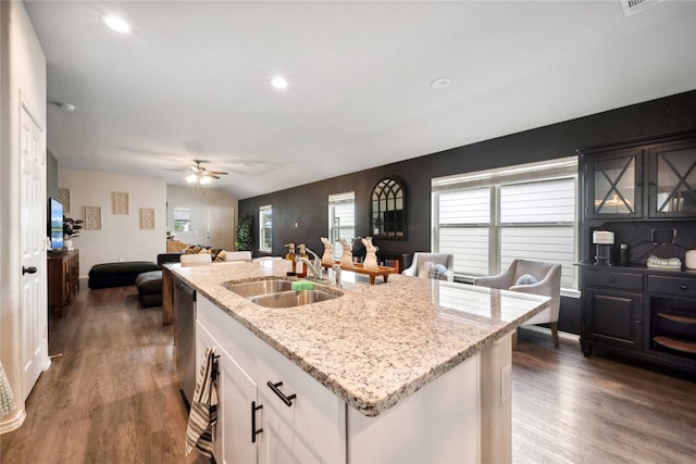 25388 Leather Leaf Ct, Montgomery, TX 77316 - kitchen with light stone countertops, a sink, and dark wood-type flooring
