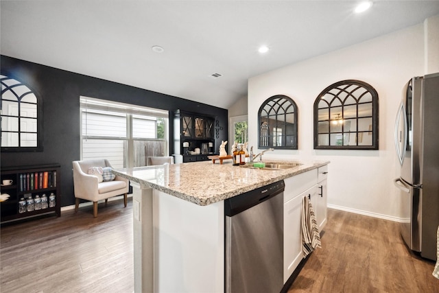 25388 Leather Leaf Ct, Montgomery, TX 77316 - kitchen with a sink, stainless steel appliances, wood finished floors, light stone counters, and white cabinets