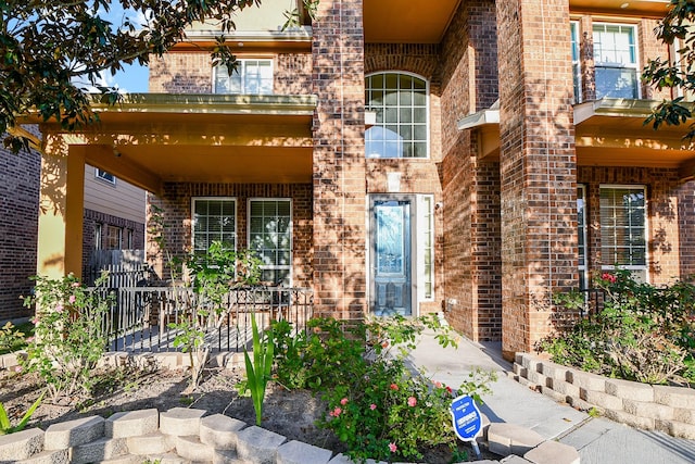 view of exterior entry with brick siding