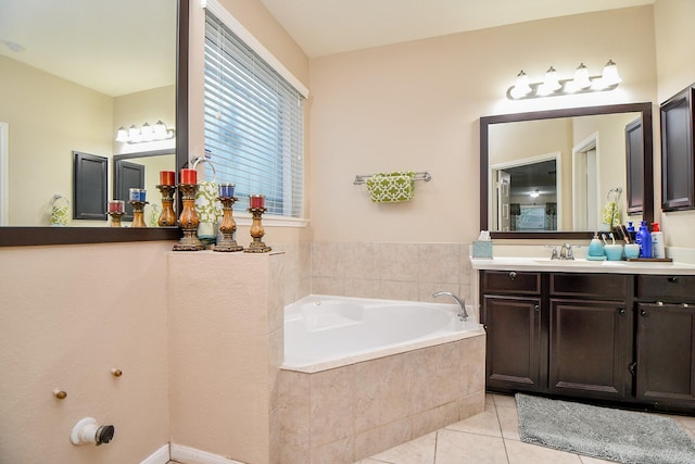 bathroom with tile patterned floors, vanity, and a bath