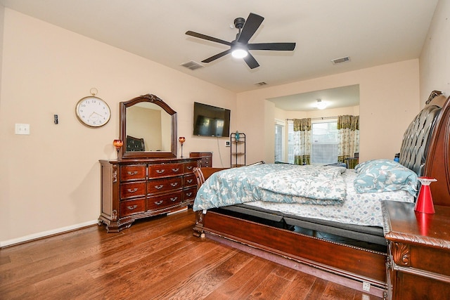 bedroom featuring visible vents, wood finished floors, and ceiling fan