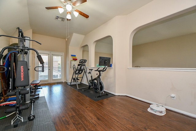 exercise room with baseboards, ceiling fan, visible vents, and wood finished floors
