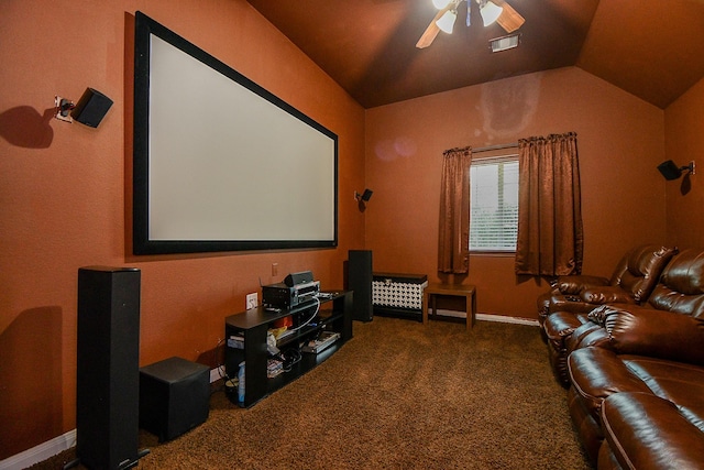 carpeted home theater room with visible vents, lofted ceiling, and a ceiling fan