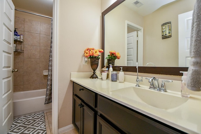 full bathroom with shower / bath combo, tile patterned floors, visible vents, and vanity