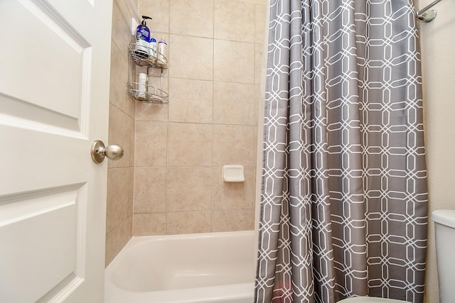 full bathroom featuring toilet and shower / bath combination with curtain