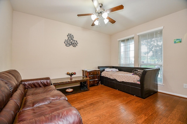 bedroom with baseboards, a ceiling fan, and wood finished floors