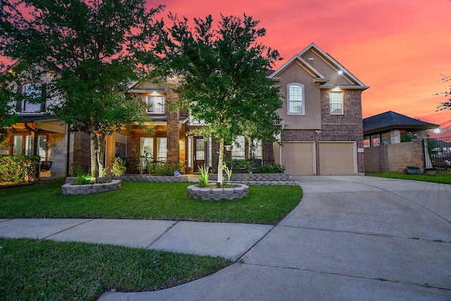 view of front facade with brick siding, fence, a garage, concrete driveway, and a front yard