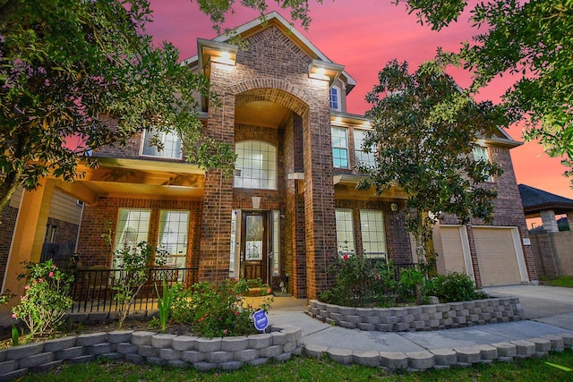 view of front of home with concrete driveway, a garage, and brick siding