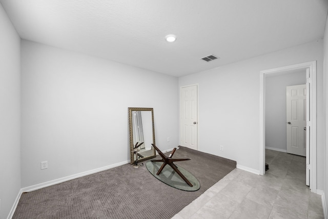 interior space featuring baseboards, recessed lighting, and visible vents