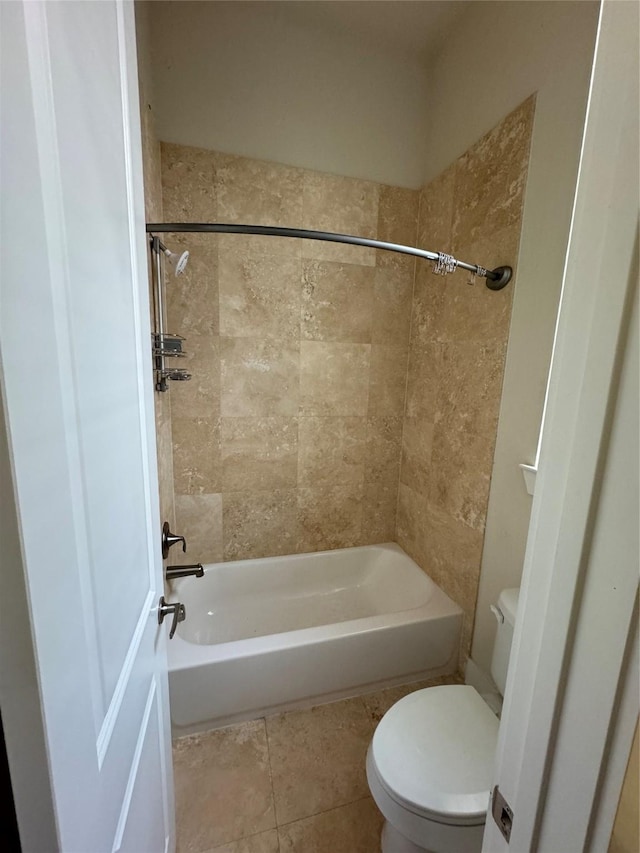 bathroom with toilet, tile patterned floors, and bathing tub / shower combination