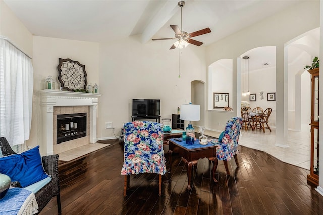 19231 Kelly Pines Ct, Humble, TX 77346 - living area with a fireplace, ceiling fan, arched walkways, and hardwood / wood-style floors