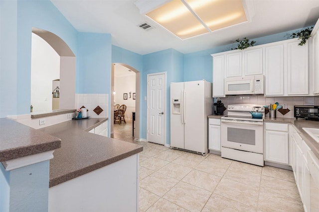 19231 Kelly Pines Ct, Humble, TX 77346 - kitchen featuring white cabinetry, white appliances, arched walkways, and visible vents