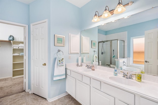 19231 Kelly Pines Ct, Humble, TX 77346 - bathroom with double vanity, baseboards, a shower stall, and a sink
