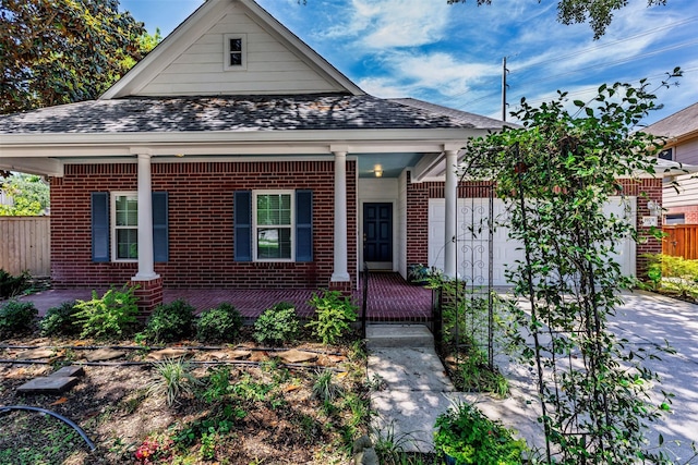 19231 Kelly Pines Ct, Humble, TX 77346 - view of front of house featuring covered porch, roof with shingles, fence, and brick siding