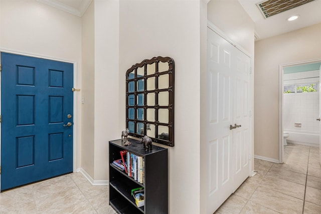 19231 Kelly Pines Ct, Humble, TX 77346 - foyer entrance featuring crown molding, baseboards, light tile patterned floors, and visible vents