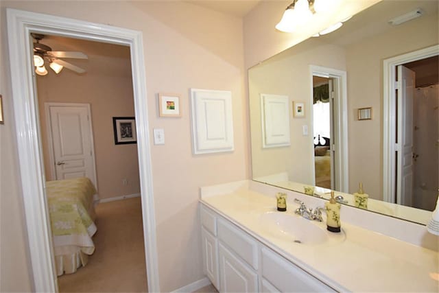 bathroom featuring vanity, baseboards, and a ceiling fan