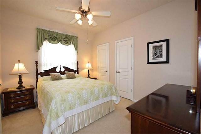 bedroom with light colored carpet and a ceiling fan
