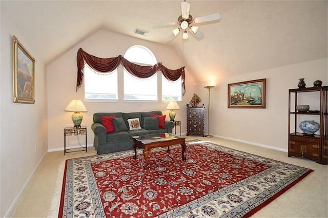 carpeted living room with lofted ceiling, baseboards, visible vents, and a ceiling fan